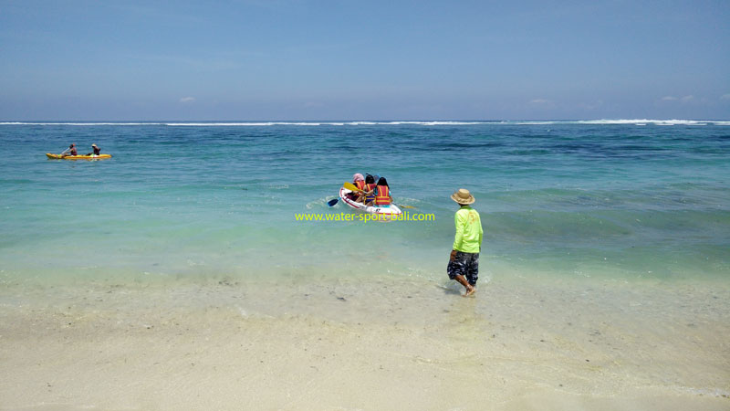 Visitors enjoying water activities at Pandawa Beach's clear, shallow waters.