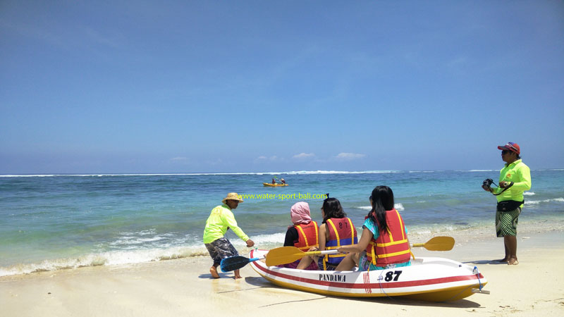 Tourists prepare to ride a canoe at Pandawa Beach, Kutuh, Bali