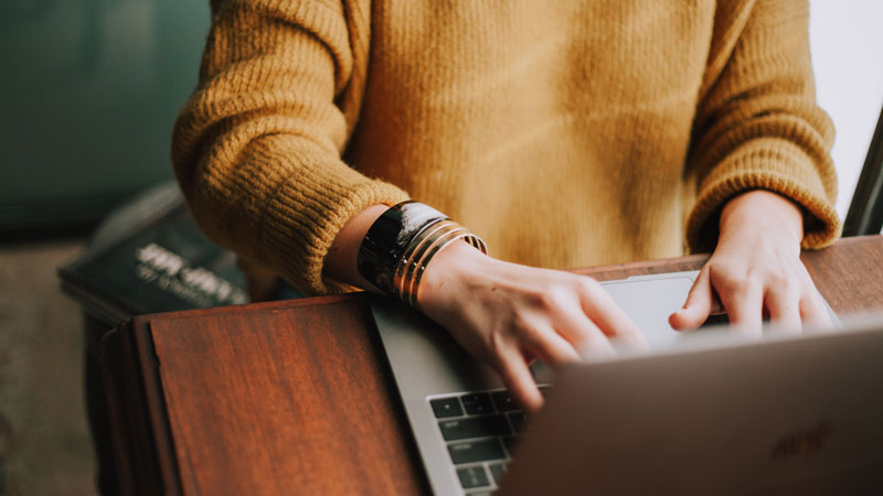 Content creator planning Bali water sports activities for non-swimmers on a laptop