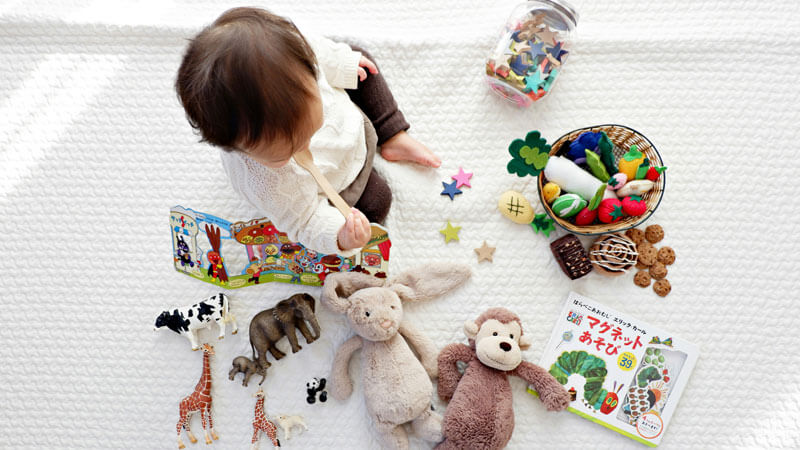 Toddlers have fun playing with educational toys and picture books. Travel Tips To Bali With Toddlers, Babies, and Children