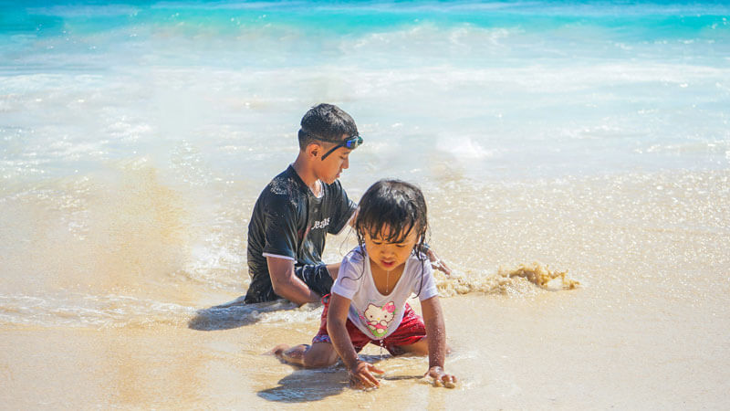 Families play on a child-friendly Bali beach