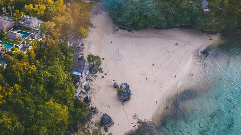 Aerial view of Padang-Padang Beach with white sand and clear blue waters in Bali