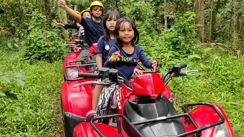 Family enjoying a quad bike adventure through Ubud's lush greenery, a kid-friendly activity in Bali.