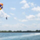 Parasailing participants enjoyed views of the blue sea above Tanjung Benoa, Bali. FAQ Parasailing Bali