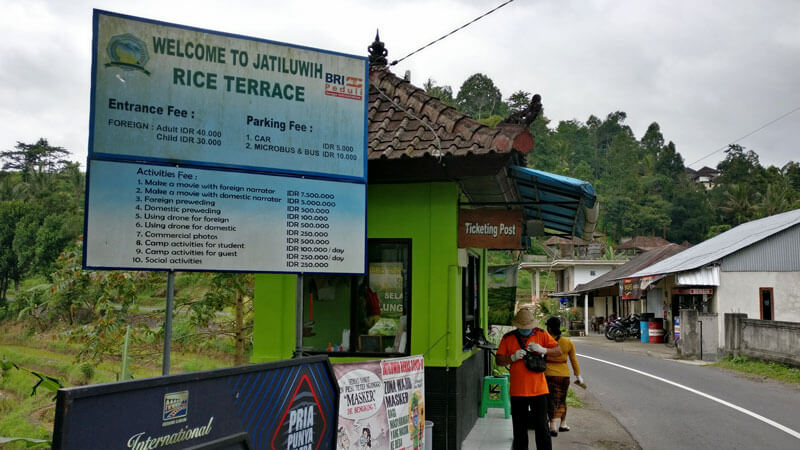 Ticket booth at Jatiluwih Rice Terrace displaying entrance and activity fees for visitors