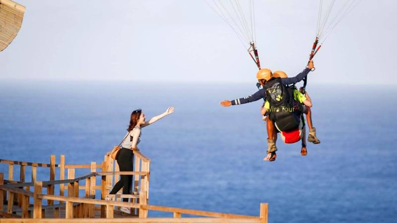 Soaring above Bali’s stunning coastal regions with Riug Paragliding.