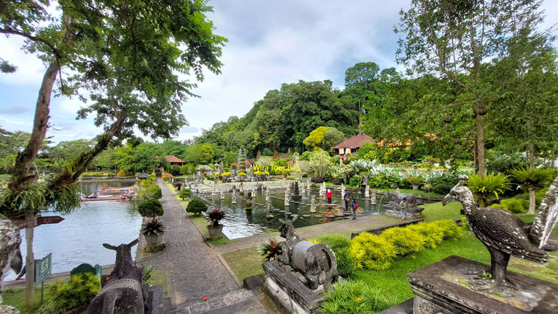 Lush gardens and fountains at Tirta Gangga Water Palace in Bali