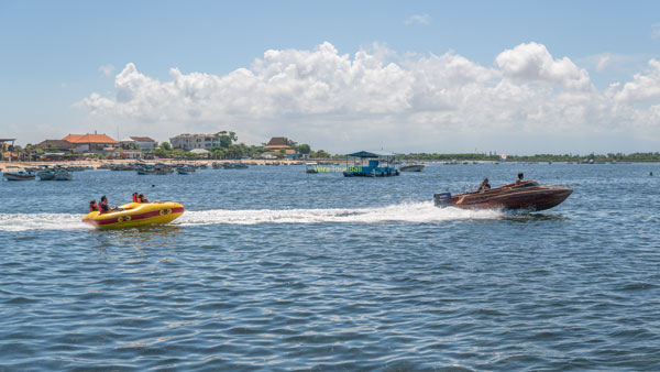 Speed boat pull boat on Rolling Donut Watersport