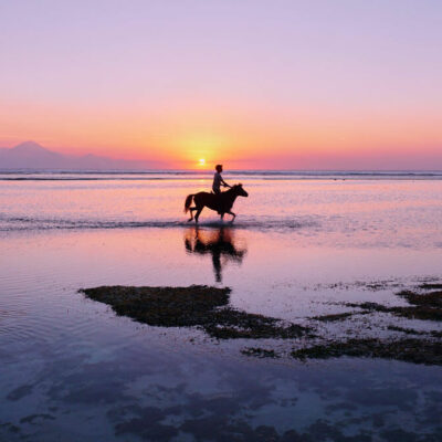 Gili Trawangan sunset with horse rider silhouette.