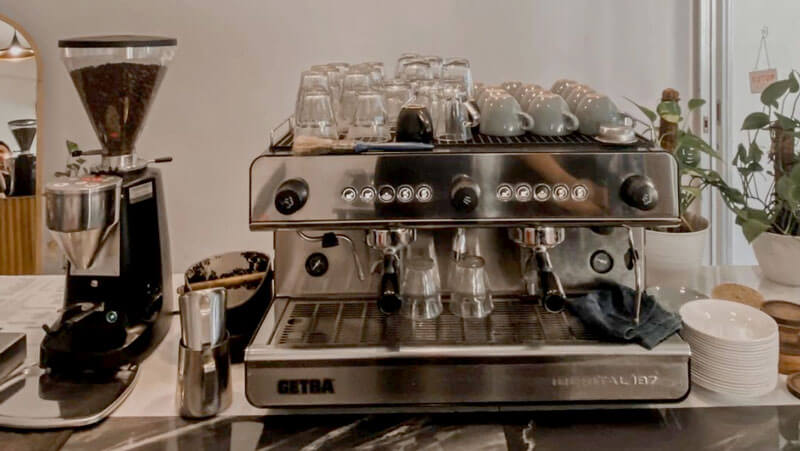 Sleek espresso machine setup with coffee grinder and accessories at Sekala Kopi Denpasar