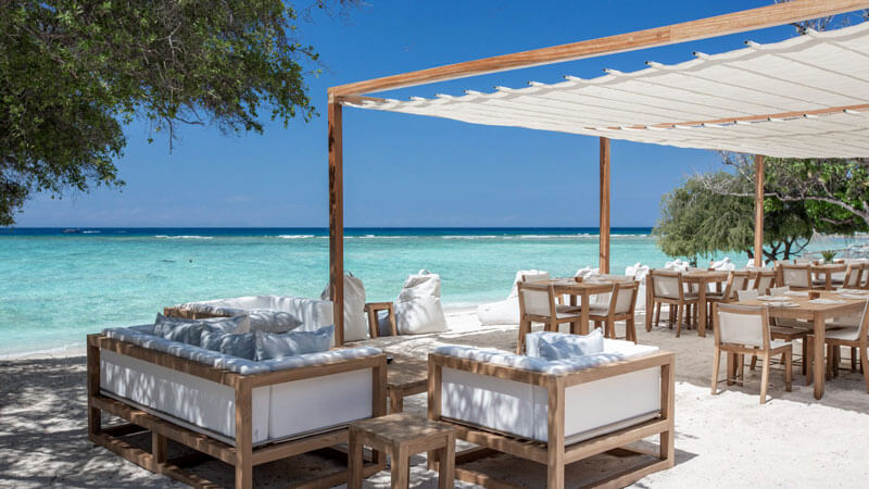 Beachside seating area at Pondok Santi Estate Luxury Resort in Gili Trawangan.