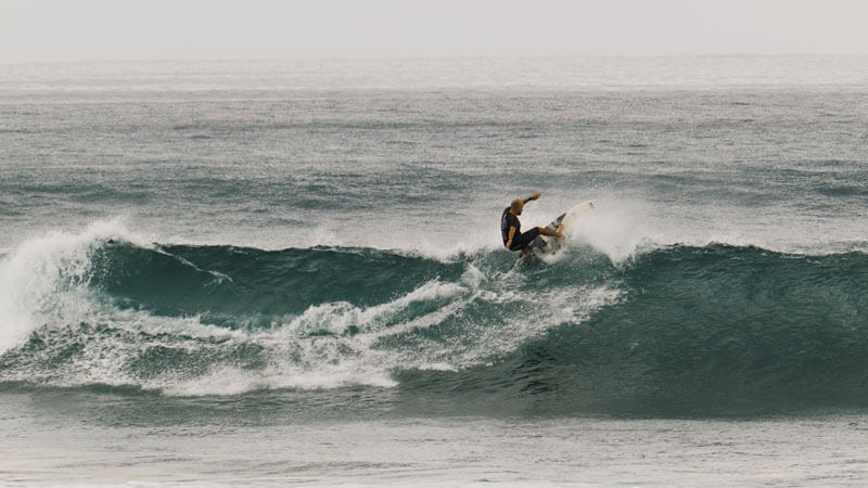 Tourists surfing at Legian Beach