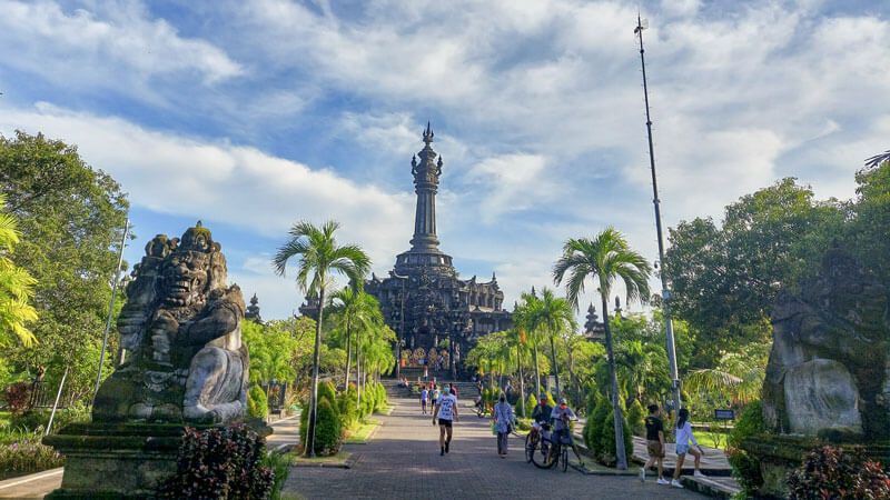 Bajra Sandhi Monument in Denpasar Bali, a towering structure amidst tropical greenery symbolizing Balinese struggle for independence.