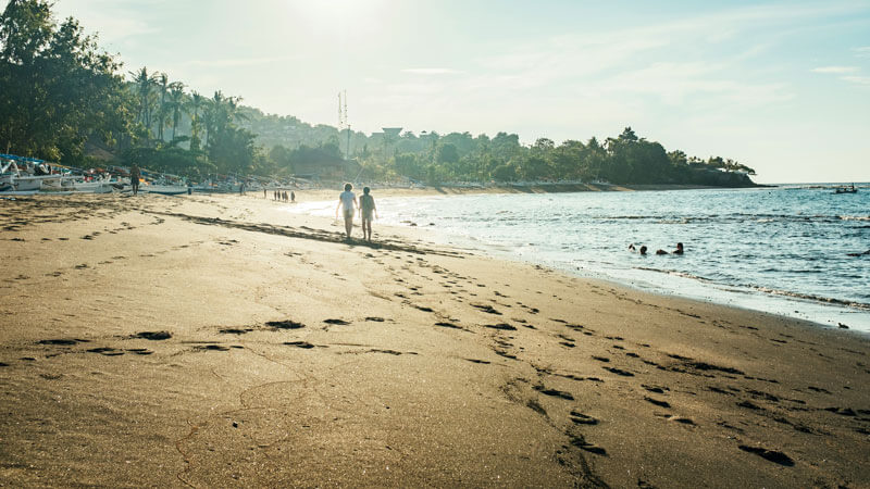 Serene beachscape with footprints in sand at dawn in East Bali