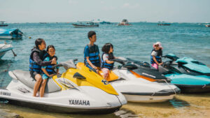 Family with children in life jackets ready for a jet ski ride in Bali