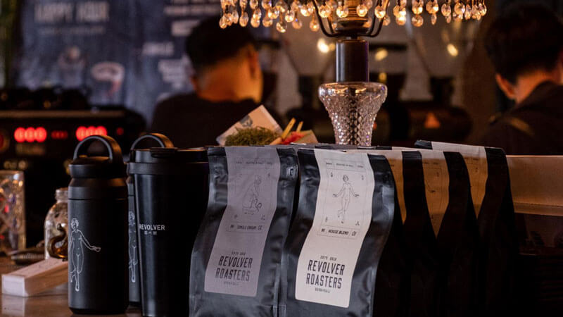 Revolver Roasters coffee bags lined up at Revolver Espresso Kafe in Seminyak.