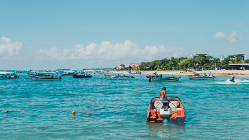 Speedboat activities at the vibrant Tanjung Benoa Beach, Bali's hotspot for water sports and leisure.