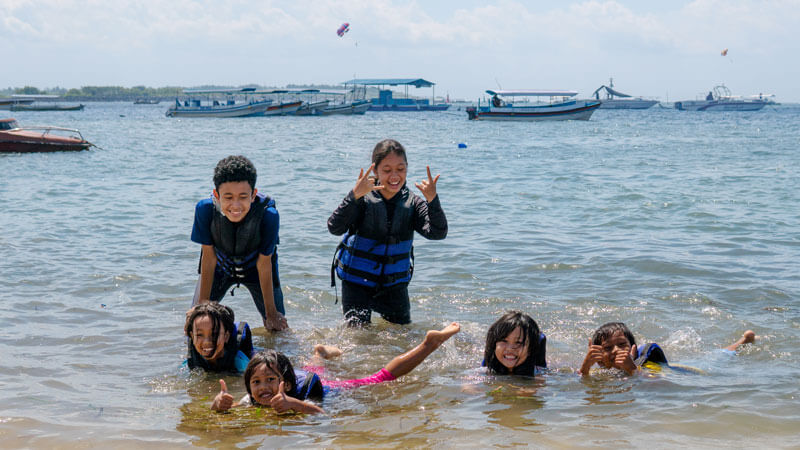 Children Having Fun on Bali Beach in Water Sports Clothes