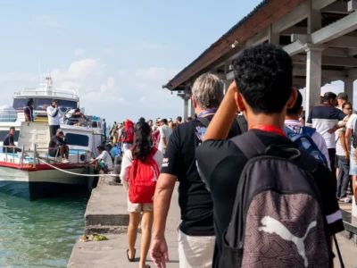 Tourists prepare to board a fast boat at Padang Bai Harbor