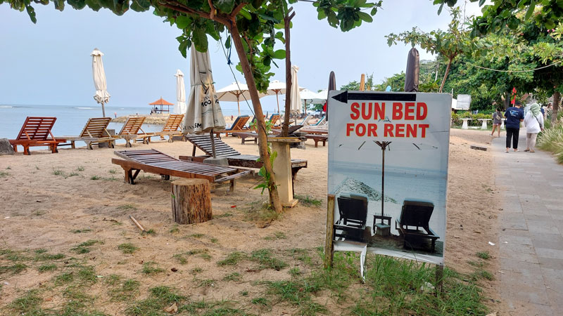 Sunbeds for rent on Sanur Beach, offering a peaceful and relaxing experience.