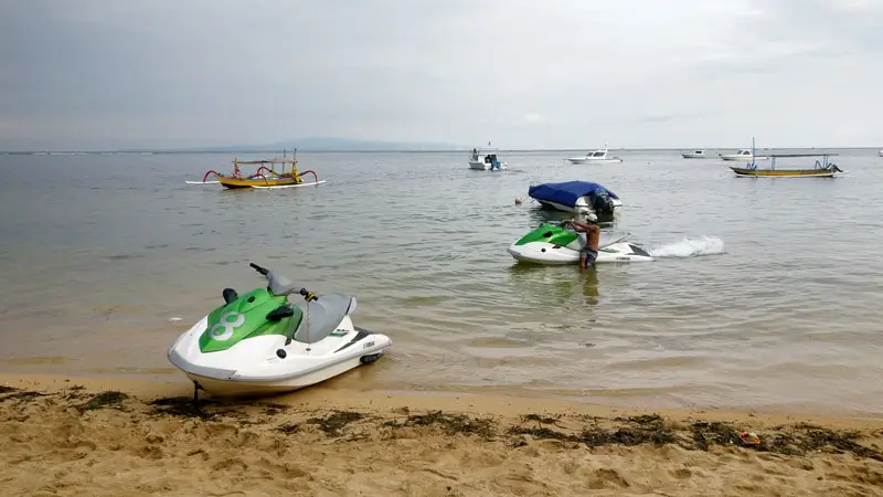 Jet skis on Sanur Beach, ready for water sports activities.