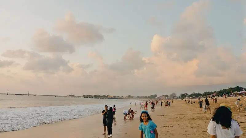 Visitors enjoying a lively afternoon at Jimbaran Beach Bali. © Wira Tour