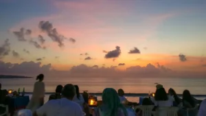 Sunset seafood dinner on Jimbaran Beach with pastel sky and candles