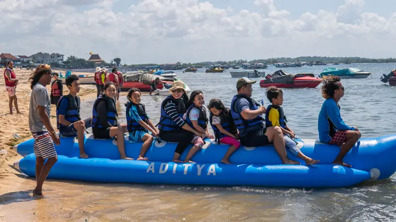 Family group sitting on banana boat before ride in Tanjung Benoa
