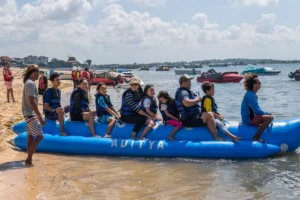 Smiling family on banana boat at Tanjung Benoa Beach Bali
