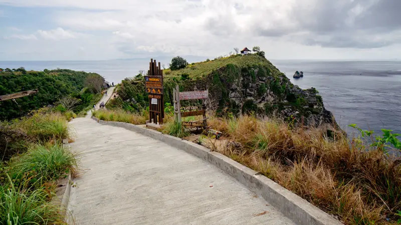 Trail fork signage showing access to two east coast beaches on Nusa Penida