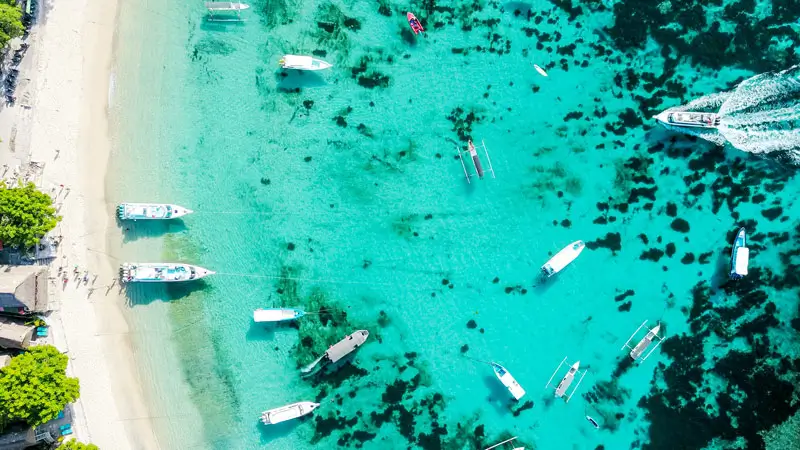 Aerial view of boats anchored in turquoise water at Mushroom Bay, Nusa Lembongan