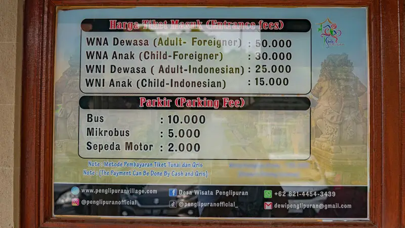 Entrance & parking fee board at Penglipuran Village: WNI 25,000/15,000; WNA 50,000/30,000; parking 10,000/5,000/2,000