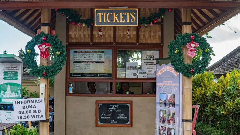 Penglipuran ticket counter exterior with hours notice 08:00–18:30 WITA
