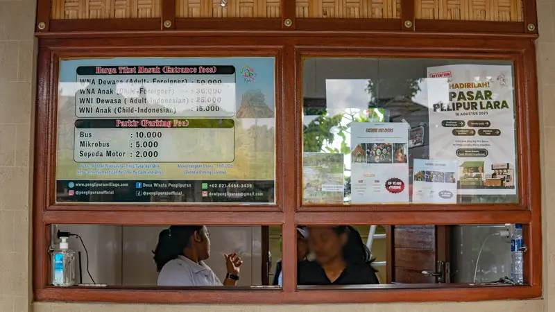 Penglipuran Village entrance fee board, IDR: Indonesian 25,000/15,000; International 50,000/30,000