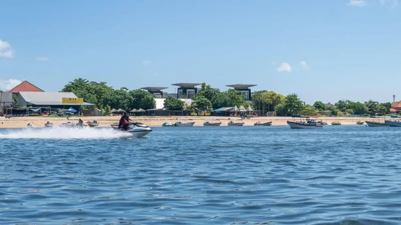 Shoreline view with activity boats in a calm bay near Nusa Dua