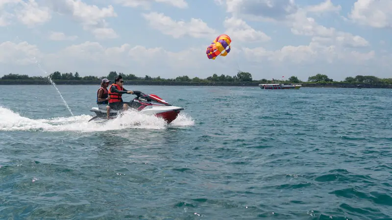 Tanjung Benoa Water Sports calm morning bay with escorted Jet Ski and parasail in the distance