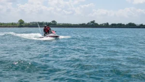 Where to jet ski in Bali: rider in life jackets on a jet ski with guide on calm blue water