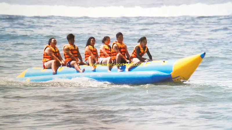 Sanur Banana Boat session with six riders on blue raft starting a gentle tow