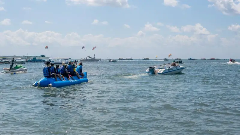 Banana boat Tanjung Benoa ride towed by speedboat on calm water