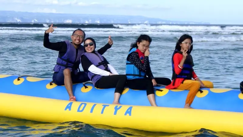 Family on a private inflatable tow, wearing life jackets