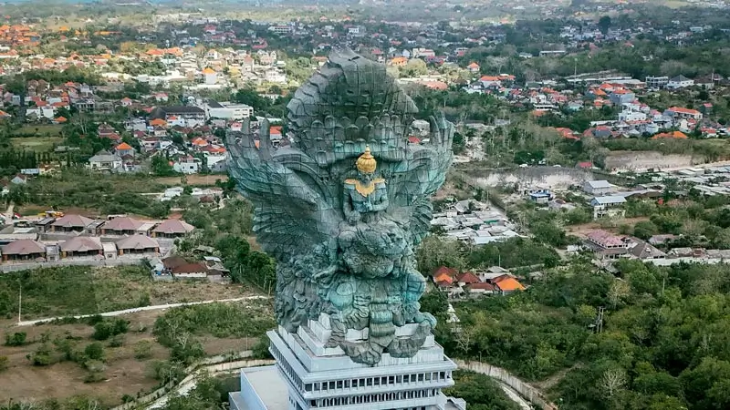 Aerial view of a large cultural statue complex surrounded by greenery