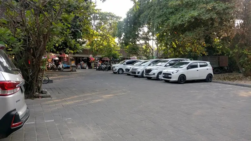 Sanur beach parking area near access path, morning scene