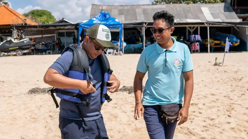 Staff assisting guest with life jacket