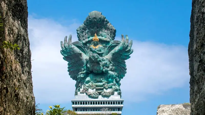 Garuda Wisnu Kencana statue framed by limestone cliffs at GWK Cultural Park Bali