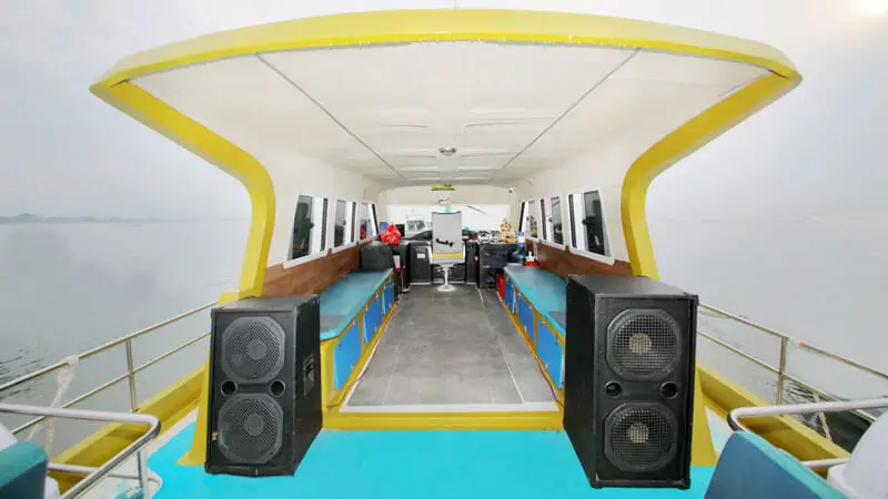 Upper deck seating area with benches and speakers