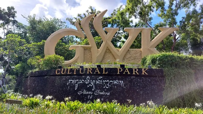 Entrance sign of GWK Cultural Park Bali surrounded by trees and greenery