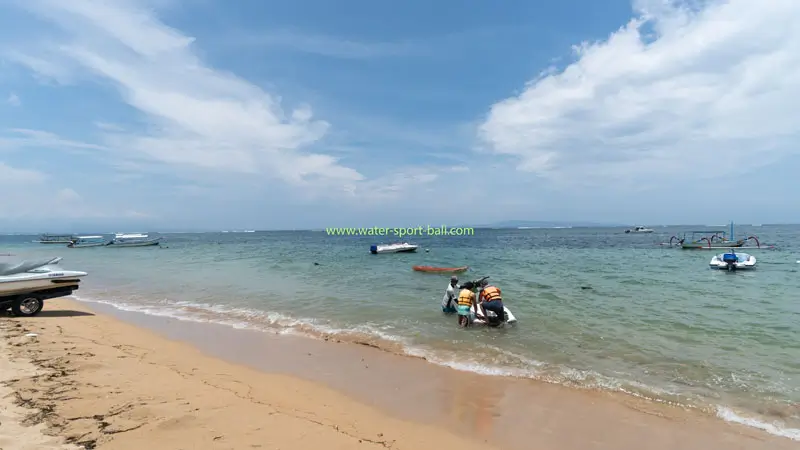 Sanur Beach shoreline with calm sea and jet ski launch area