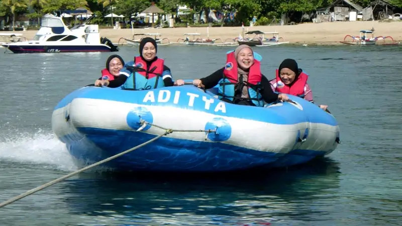 Riders on Aditya Water Sport donut tube during a tow session