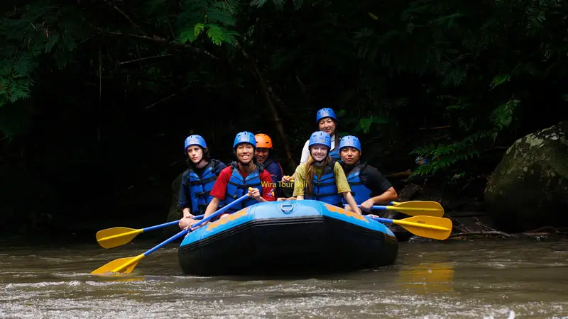 Group rafting on the Ayung River in Bali wearing helmets and life jackets