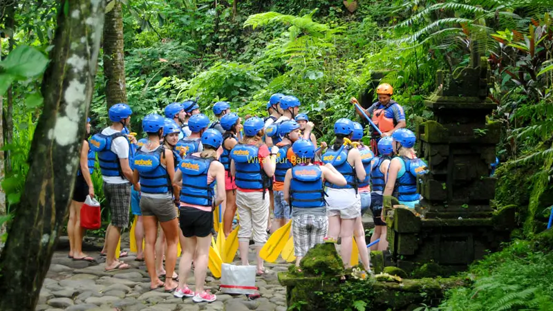 Guide giving a safety briefing before river rafting in Bali